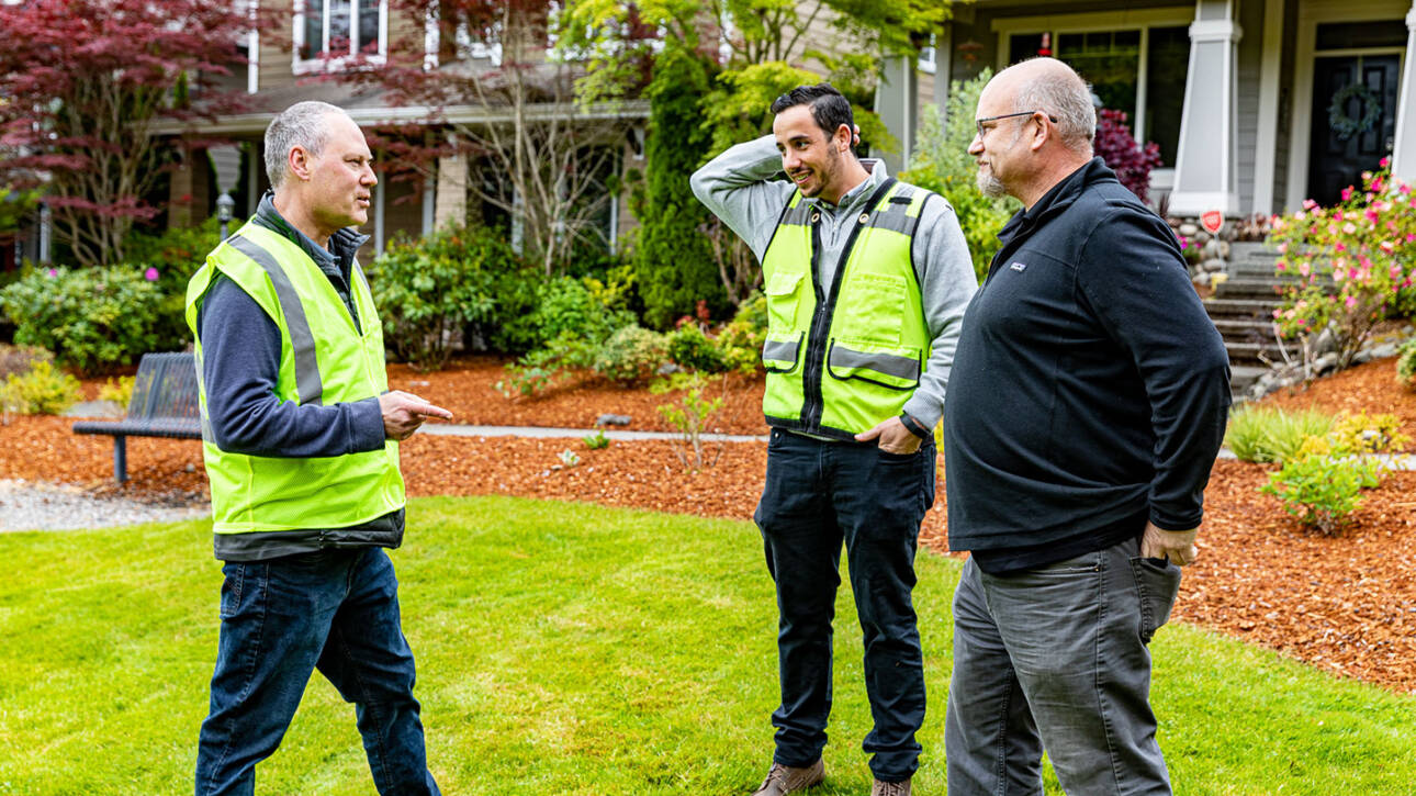 men talking in yard about tiny home