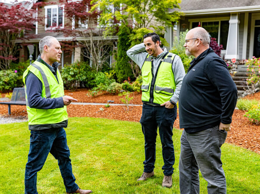 men talking in yard about tiny home